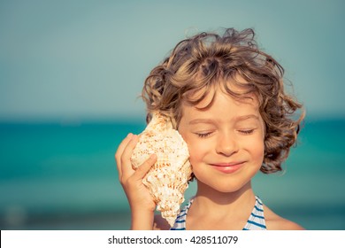 Child relaxing on the beach against sea and sky background. Summer vacation and travel concept - Powered by Shutterstock