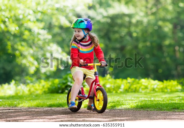 kid riding balance bike