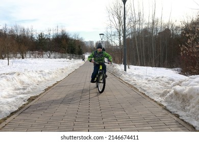 Child Riding Bike On Sidewalk In Spring