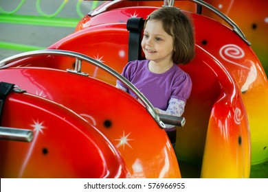 Child Riding On A Roller Coaster