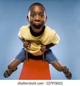 Child Riding On A See Saw.