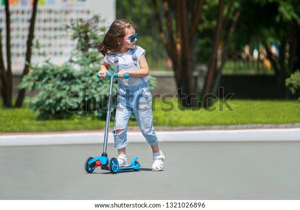 child riding scooter