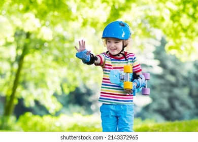 Child Riding Skateboard In Summer Park. Little Boy Learning To Ride Skate Board. Active Outdoor Sport For School And Kindergarten Kids. Children Skateboarding. Preschooler On Longboard. Kid Skating.