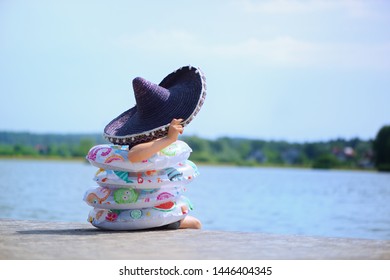 Child With Rings For Swimming. Parent Overprotection Concept.