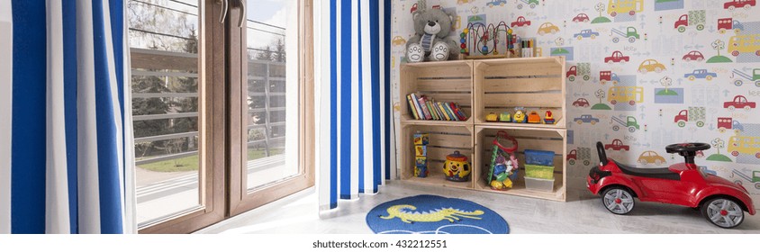 Child Room For A Boy With Toys And Wallpaper With Cars