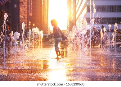 Child Run And Play On Street Fountain On Philadelphia Square Over Sunset Near City Hall In Downtown