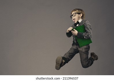 Child Running Back To School, Funny Kid Portrait, Jumping Smart Schoolboy With Glasses And Book