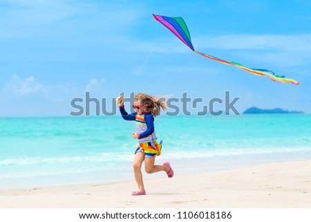 Similar – Image, Stock Photo Flying rainbow kites coast