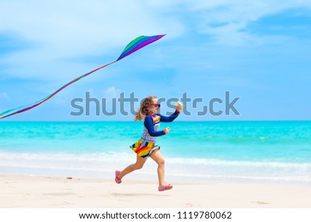 Similar – Image, Stock Photo Flying rainbow kites coast