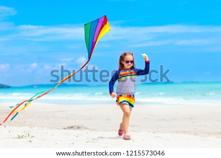 Similar – Image, Stock Photo Flying rainbow kites coast