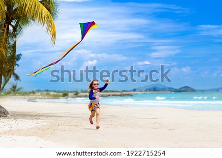 Similar – Image, Stock Photo Flying rainbow kites coast