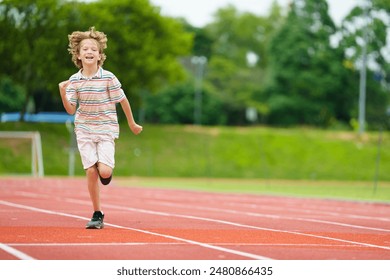 Child running on stadium. Kid exercising in athletics club. Young athlete in race competition. Healthy outdoor sport for kids. Children run. - Powered by Shutterstock