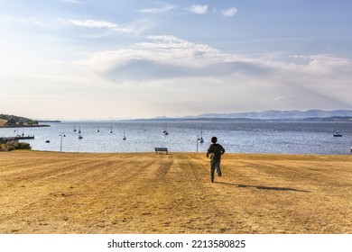 Child Running Towards The River Forth, Scotland