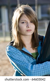 Child With Sad Expression Standing Alone On Playground (11 Years)