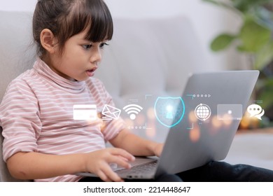 Child Safety Online. Little Girl Using Laptop At Home. Icon Of Internet Blocking App On Foreground