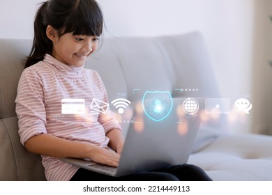 Child Safety Online. Little Girl Using Laptop At Home. Icon Of Internet Blocking App On Foreground