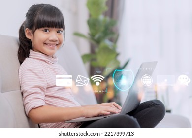 Child Safety Online. Little Girl Using Laptop At Home. Icon Of Internet Blocking App On Foreground