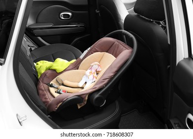 Child Safety Seat With Cute Toy In Car
