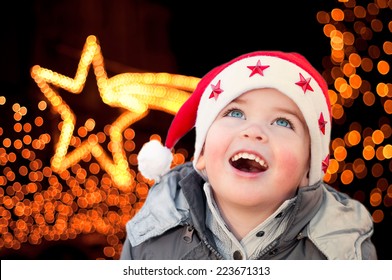 Child With Santa Claus Hat Looking At Christmas Lights