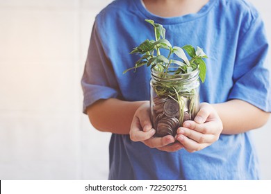 Child Saving Money In Bottle Money Growing Up As Tree