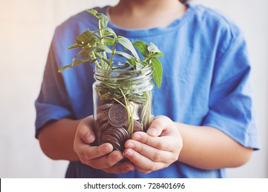 Child Saving Money In Bottle Money Growing Up As Tree