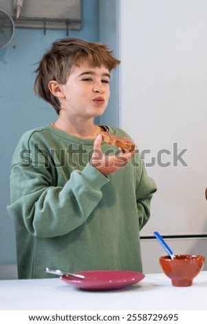 Similar – Image, Stock Photo Young child savoring a blue lollipop enthusiastically