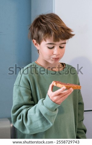 Similar – Image, Stock Photo Young child savoring a blue lollipop enthusiastically