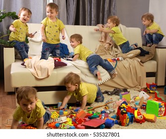 Child Scattered Toys. Children's Room. Mess In The House. A Lot Of Children, Madness In The Children's Room. Children Jumping On Couch