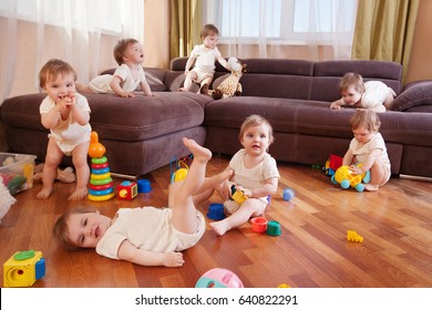 Child Scattered Toys. Mess In The House. A Lot Of Children. The Little Girl Plays In The Room.
