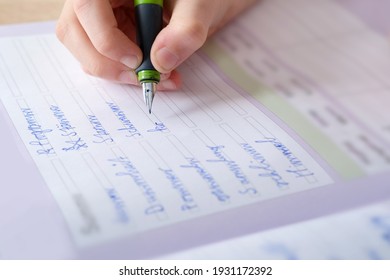 child, schoolboy, writes words in German in a notebook with an ink fountain pen, education concept, elementary school, hand development