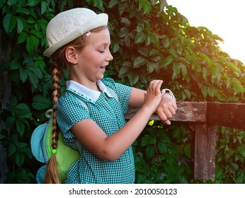 Child Schooler Using Smartwatch Outdoor Park. Kid Talking On Vdeo Call With Parents On Smartwatches. Schoolgirl Searching On The Internet Using Watches Touchscreen Display.Smart Wristwatch GPS Tracker