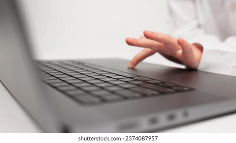 Child schoolgirl girl typing keyboard using laptop with touch screen, online course of educational lessons at home. Distance learning course, remote video conference. Schoolgirl studying at school - Powered by Shutterstock