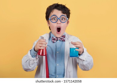 Child Scientist In Laboratory On Yellow Background