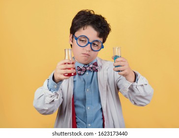 Child Scientist In Laboratory On Yellow Background