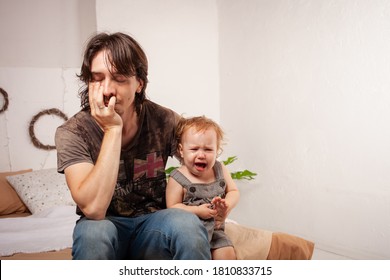 The Child Is Screaming, Hysterical. A Tired Dad Doesn't Want To Hear The Baby. The Parent Is Irritated, Tired, Wants To Take A Break From His Daughter. Children's Hysteria.