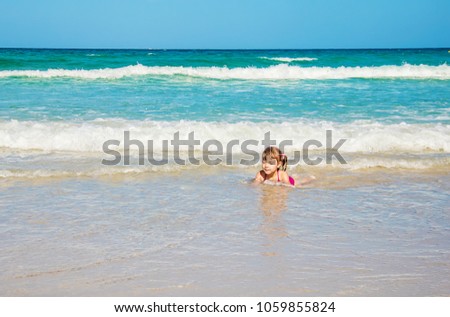 Child in the sea. Selective focus. 
