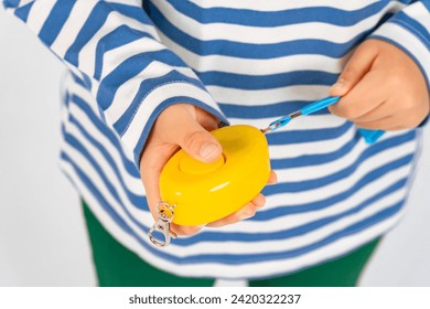 child with security buzzer in hand