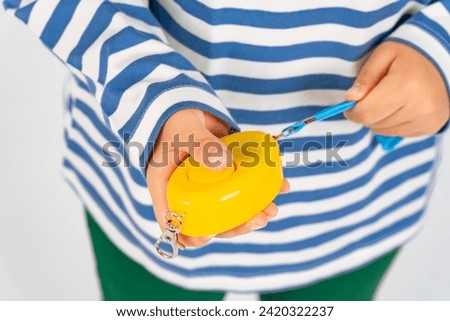 child with security buzzer in hand
