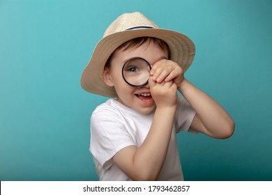 child sees through a magnifying glass on a blue background. Big baby's eye - Powered by Shutterstock