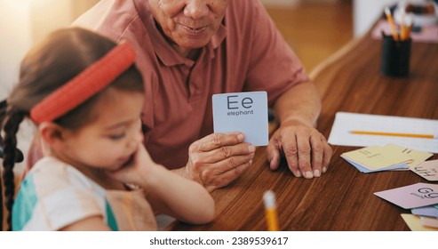 Child, senior man and education or card, teaching and learning at home, language and support. Girl, grandfather and letters or tutoring, assessment and alphabet for development or english homework - Powered by Shutterstock