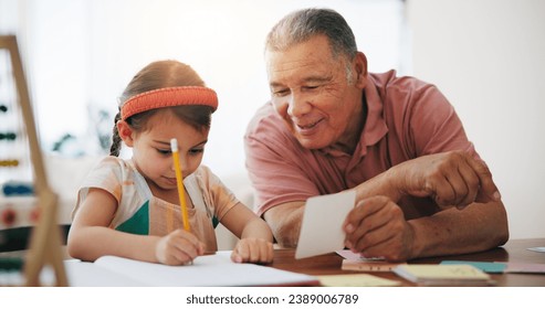 Child, senior man and education or writing, book and learning at home, drawing and support or paper. Girl, grandfather and notebook or tutoring, assessment and smile for language or math homework - Powered by Shutterstock