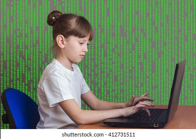 A child sitting on a chair playing laptop on a background of green matrix.