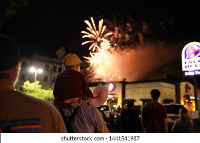 A Child Sitting On Father's Shoulders And Watching B-town Boom 4th Of July Fireworks In Downtown Bloomington, Indiana.

3rd July 2019