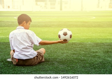 Child Sitting On Football Field Holding Stock Photo 1492616072 ...