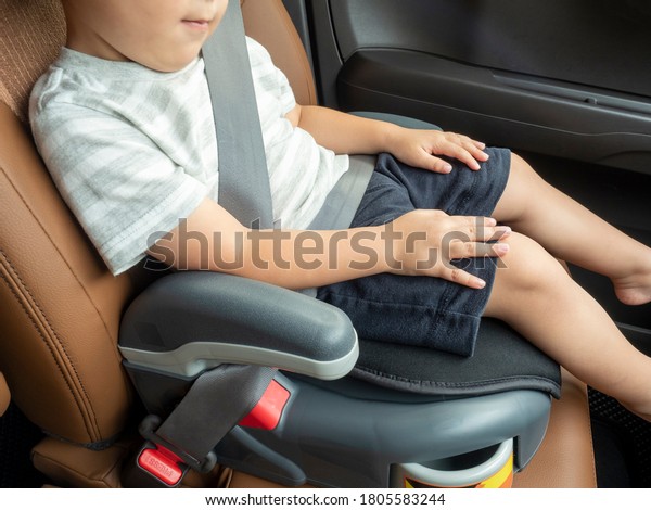 Child sitting on\
child seat with seat belt