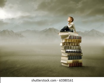 Child Sitting On A Stack Of Books In A Desert