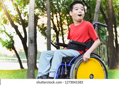 Child sitting on wheelchairs are enjoying activities in the park like other people. Happy disabled kid concept.