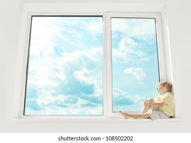 Child Sitting On Window, Enjoying Sunshine And Dreaming. Big Window And Sky.