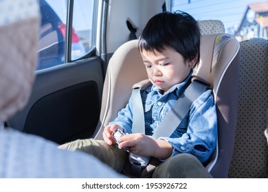 Child Sitting In A Child Seat In A Car