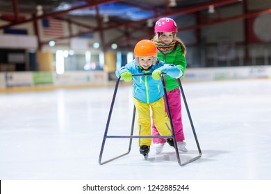 Child Skating On Indoor Ice Rink. Kids Skate. Active Family Sport During Winter Vacation And Cold Season. Little Girl And Boy In Colorful Wear Training Or Learning Ice Skating. School Sport Clubs